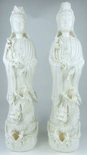 2pc CHINESE BLANC DE CHINE GUAN YIN STATUES: Two Chinese Blanc de Chine porcelain statues depicting Guan Yin with dragon. Each measures 20 1/4" x 5 1/2" x 4 3/4". Each box measures 21 1/4" x 6 1/4" 6".