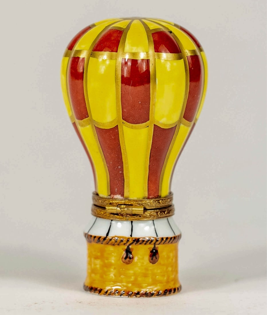 LIMOGES 'HOT AIR BALLOON' PORCELAIN TRINKET BOX: Limoges porcelain trinket box in the form of a hot air balloon. Marked to underside. Measures 2 3/4" x 1 1/2" x 1 1/2".