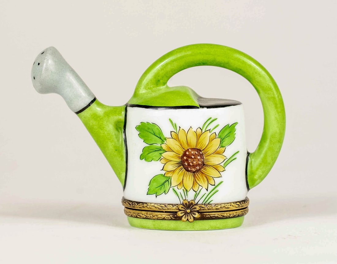 LIMOGES LA GLORIETTE 'WATERING CAN' PORCELAIN BOX: Limoges La Gloriette porcelain trinket box in the form of a watering can. Marked to underside. Measures 3 1/4" x 2 3/8" x 1 1/2".