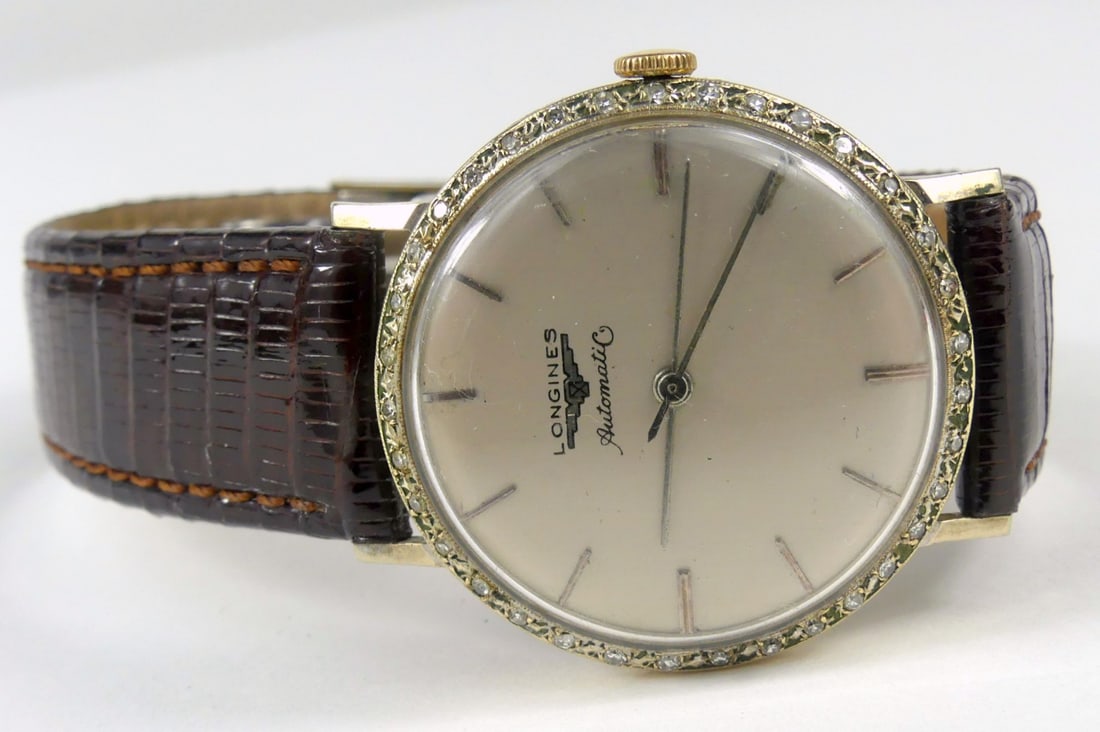 LONGINES WHITE GF WRISTWATCH w DIAMOND BEZEL: 1957 Longines wrist watch. White gold filled, sweep second hand. Leather band with metal clasp. Diamond bezel. Caliber 19AS. Case measures 38mm x 33mm.