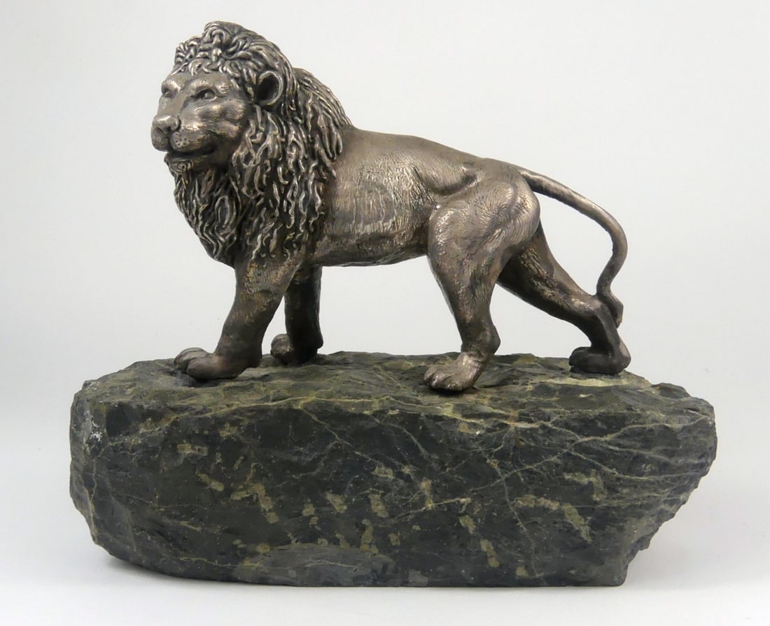 YAACOV HELLER STERLING SILVER LION SCULPTURE: Yaacov Heller sterling silver lion on solid stone base. Signed to underside of sculpture. No apparent sterling markings. Overall measures 9 1/2" x 8" x 4 1/2".