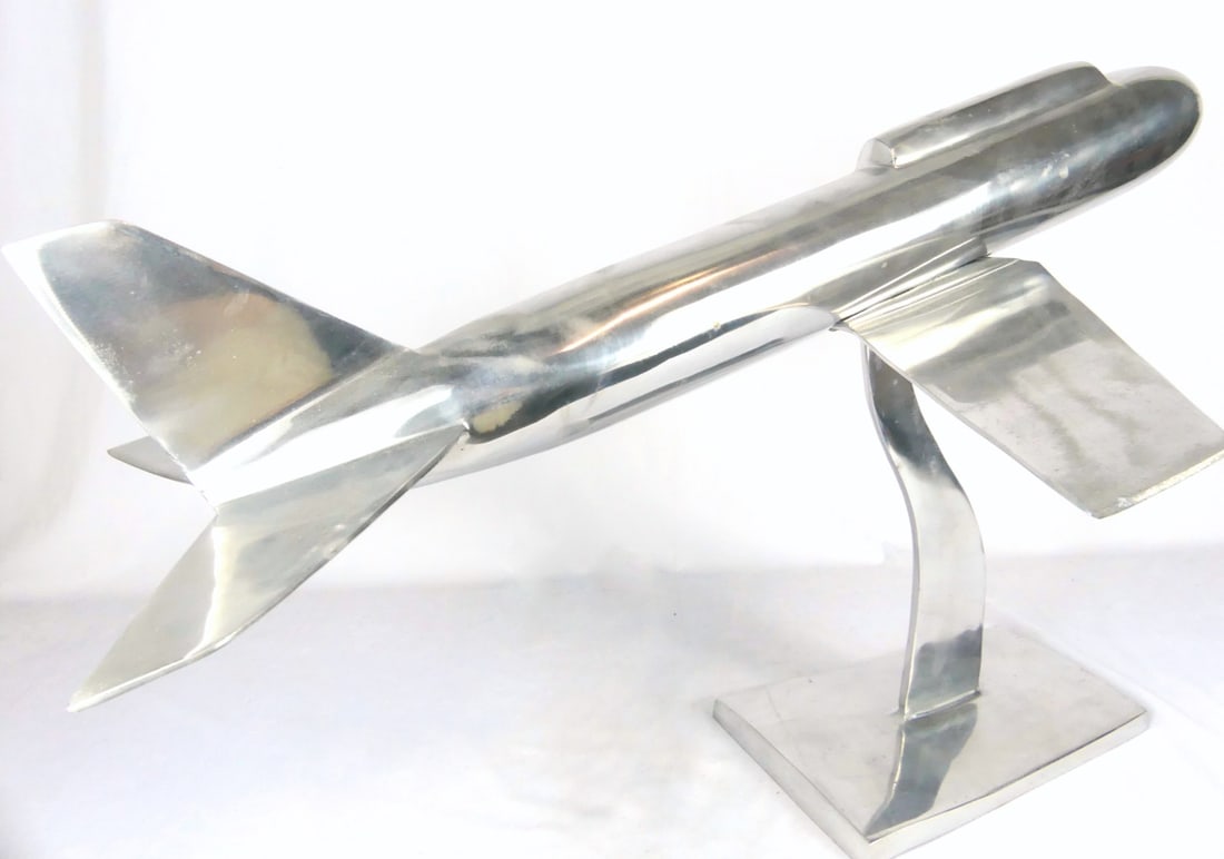 POLISHED ALUMINUM AIRPLANE SCULPTURE: Polished aluminum airplane sculpture. Measures 32" x 24" x 20 1/2" height.