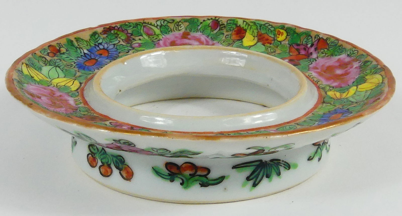 ANTIQUE CHINESE FAMILLE ROSE PORCELAIN SAUCER: Antique Chinese Famille Rose porcelain saucer of ring form. Measures 4 3/4" diameter.