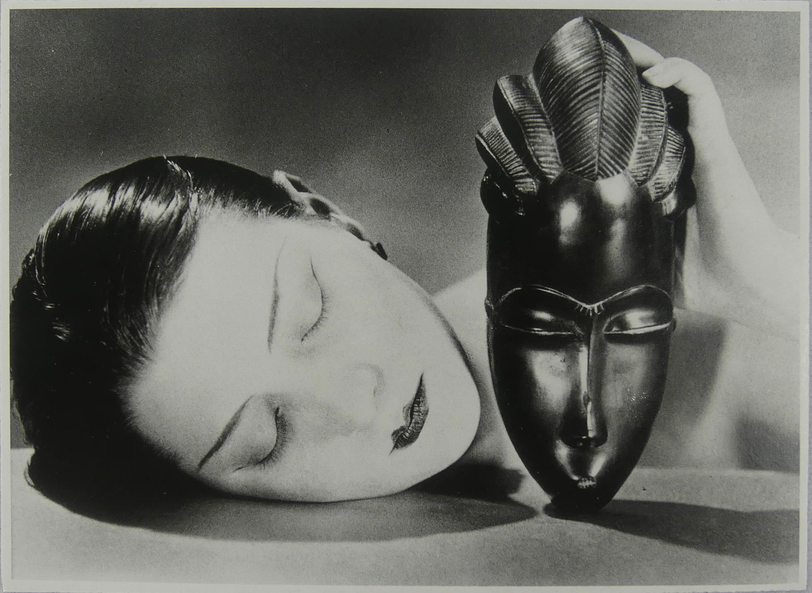 MAN RAY 'KIKI WITH AFRICAN MASK' PHOTO PRINT: Man Ray 'Kiki with African Mask' photo print. Mounted. Measures 7" x 5".