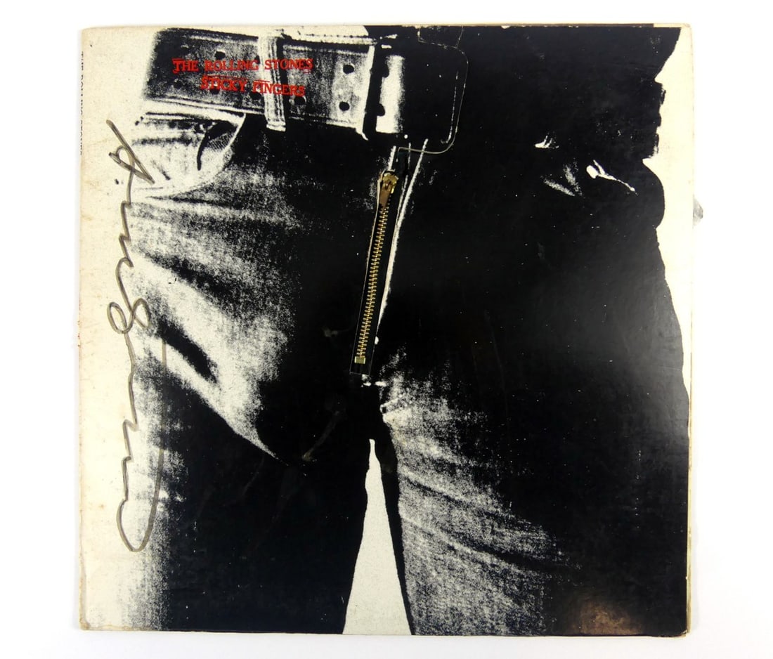 ANDY WARHOL SIGNED ROLLING STONES STICKY FINGERS: Andy Warhol The Rolling Stones Sticky Fingers album cover with vinyl record. Signed Andy Warhol in black marker to left edge. Measures 12 1/2" x 12 1/2".