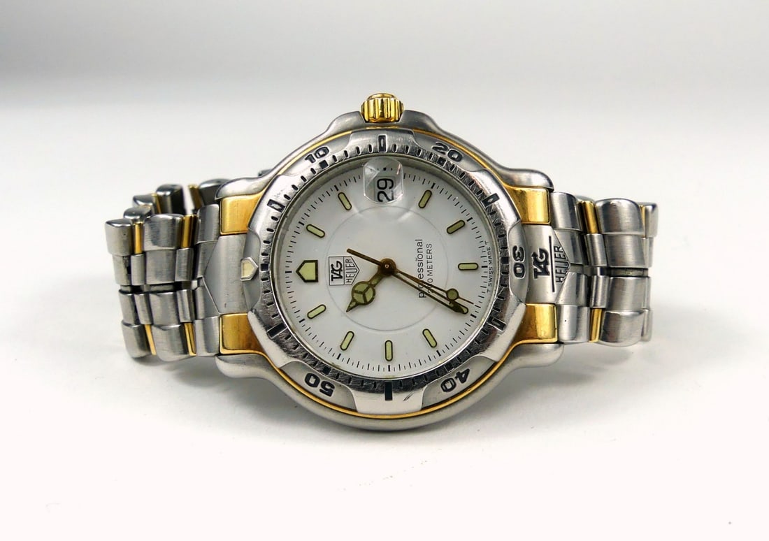 TAG HEUER 18kt & STAINLESS 6000 SERIES WRISTWATCH: Tag Heuer WH1151 600 Series Professional 18kt and stainless steel case. Original 18kt and stainless steel band. Sapphire crystal, date window, quartz. Case measures 46mm x 40mm.