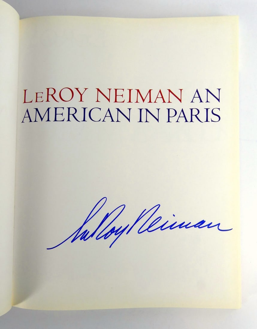 LEROY NEIMAN 'AMERICAN IN PARIS' AUTOGRAPHED BOOK: Leroy Neiman 'American in Paris' hardcover book. Signed Leroy Neiman in blue marker to cover page. Measures 14 1/2" x 12".