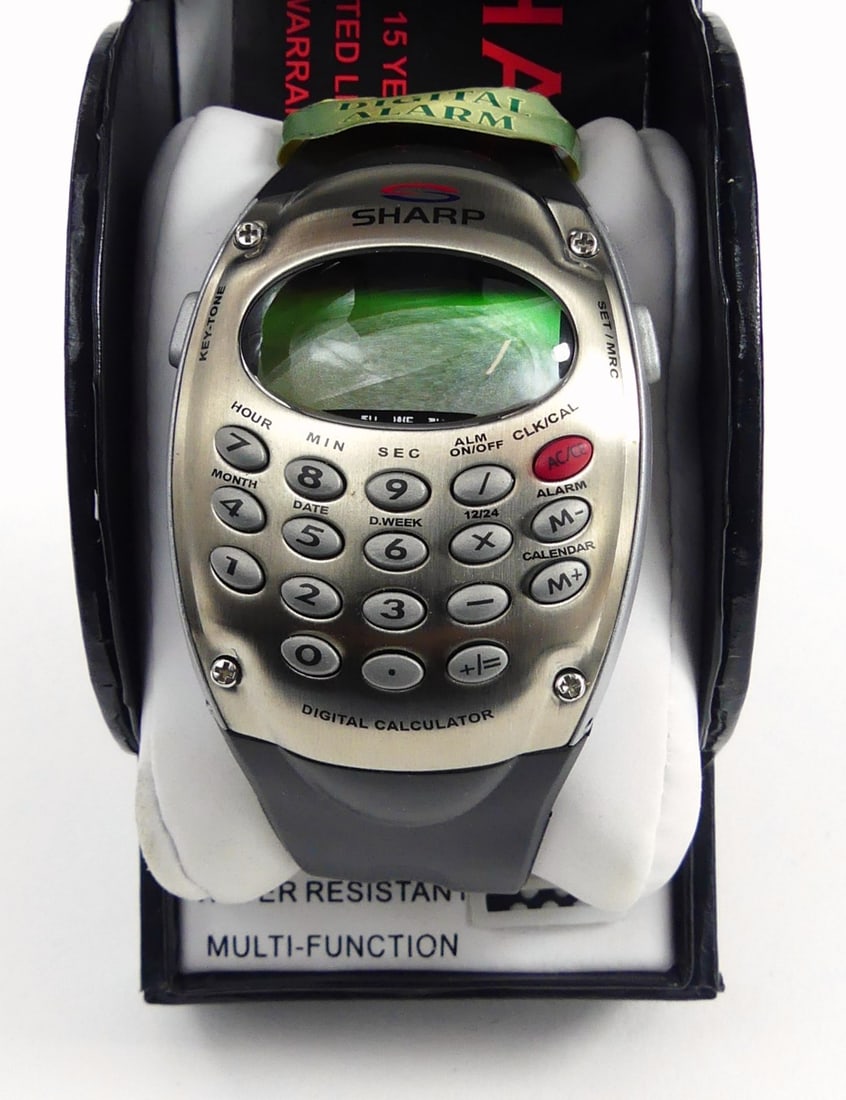 SHARP DIGITAL CALCULATOR ALARM WATCH: Sharp Digital Calculator Alarm Watch. Quartz movement, water resistant. Original box. Box measures 5" x 3 1/4" x 2 1/4".