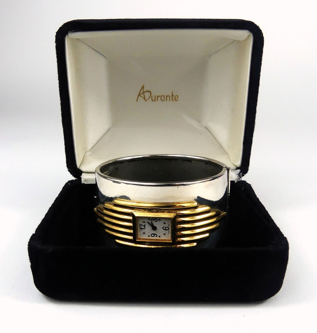 ALFRED DURANTE FRANKLIN MINT CUFF WATCH BRACELET: Alfred Durante for The Franklin Mint Art Deco cuff watch. Sterling silver plate and 22kt gold filled. Original box. Watch measures 2 1/2" x 2 1/4". Box measures 4" x 3 1/2" x 2 1/2".