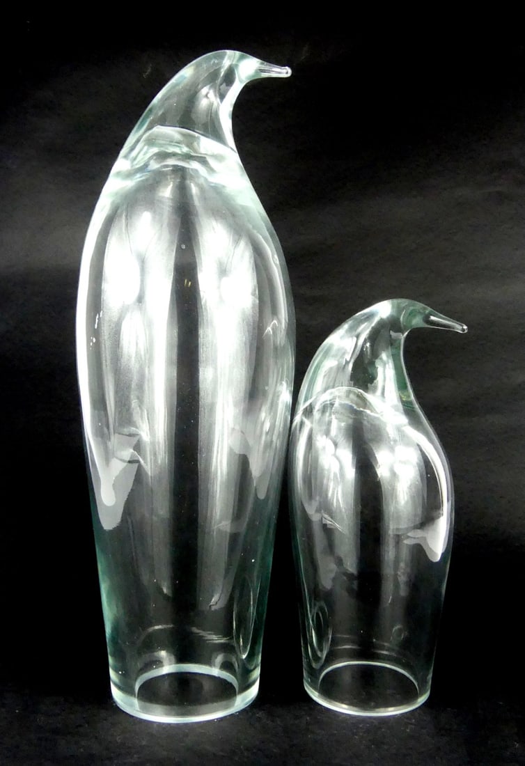 2pc BLENKO GLASS PENGUIN SCULPTURES: Two Blenko colorless glass penguin statues. Unsigned. Largest measures 15" x 5" x 5".