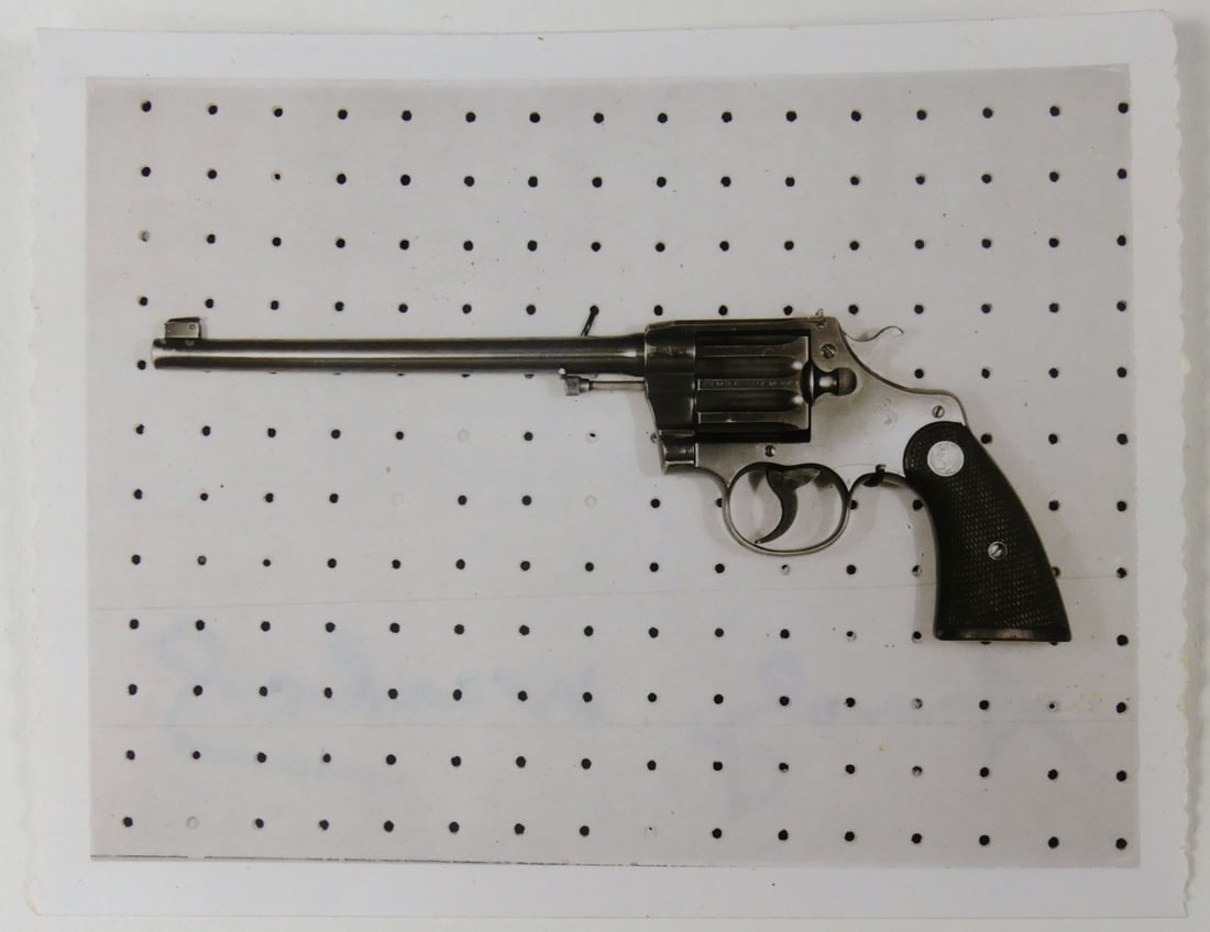 ANDY WARHOL REVOLVER PHOTOGRAPH SIGNED: Andy Warhol photograph depicting a revolver. Marker signed and holds estate stamp to verso. Measures 4 1/8" x 3 1/4".