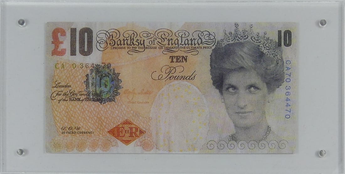 BANKSY 'DI-FACED' TENNER OFFSET LITHOGRAPH: Banksy 'Di-faced Tenner' offset lithograph on paper depicting a 10 GBP note having the face of Princess Diana instead of the Queen. Measures 5 3/4" x 3". Case measures 7 7/8" x 4".