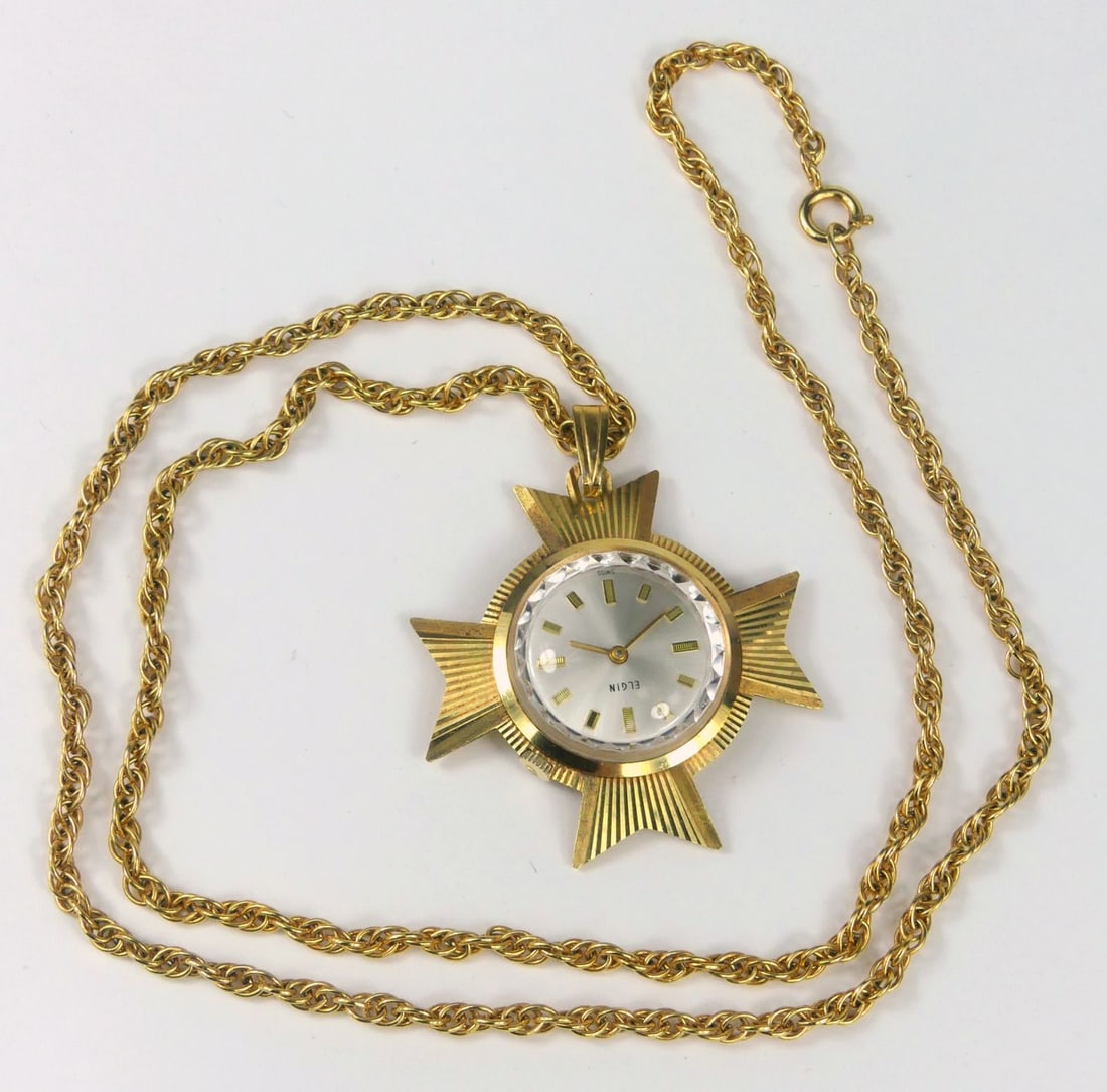 ELGIN MALTESE CROSS PENDANT WATCH: Unusual Elgin Maltese Cross pendant watch. 17 jewel Swiss 876 movement. Gold filled on a 25" gold filled chain. Good running condition. Pendant measures 52mm x 42mm.