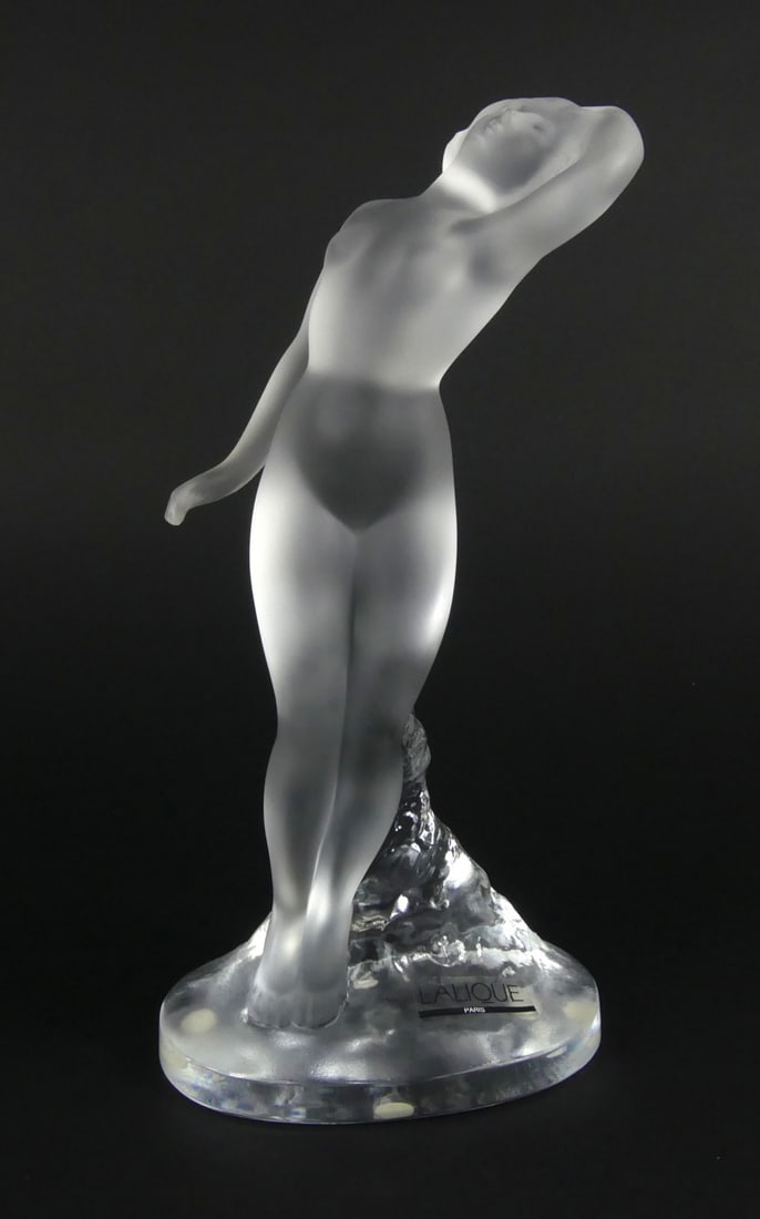 LALIQUE NUDE DANCER FROSTED CRYSTAL SCULPTURE: Lalique 'Dans Nude' French frosted crystal figure. Signed to edge of base. Holds original label. Includes box. FIgure measures 9 1/4" x 4 3/4" x 3 1/4".