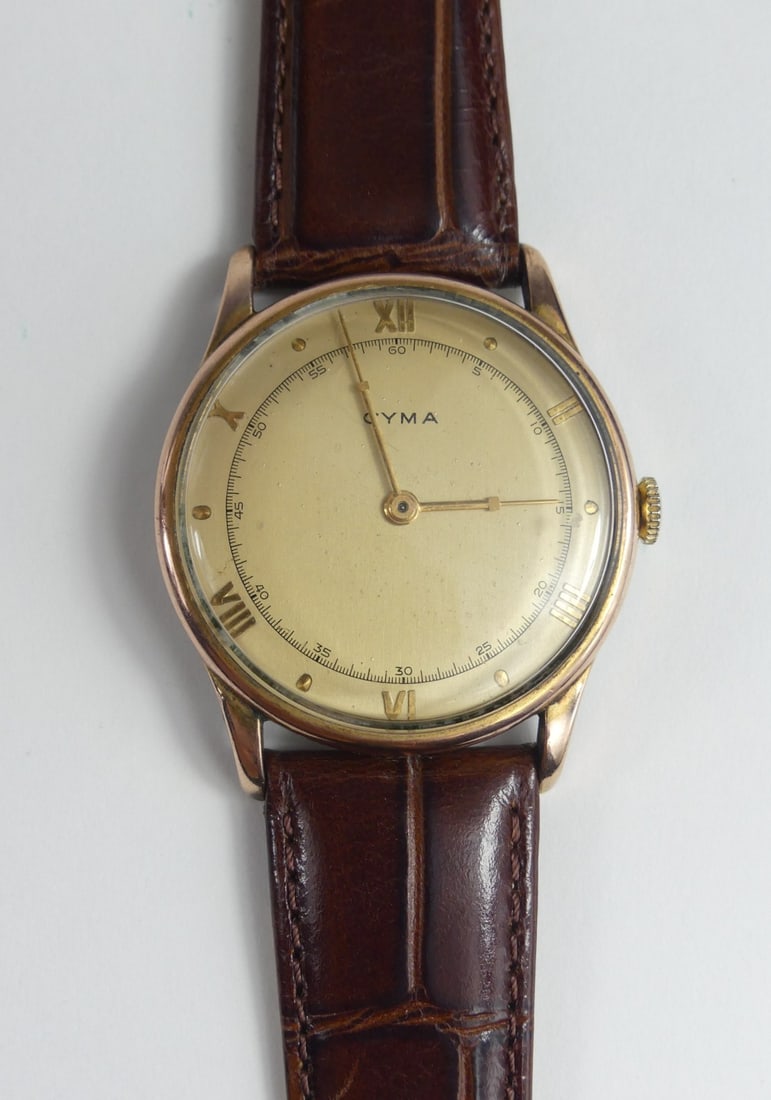 CYMA ROSE GOLD FILLED WRIST WATCH: Cyma 1940's rose gold filled with stainless back. 17 jewels. Leather band. Case measures 35mm and 41mm lug to lug.