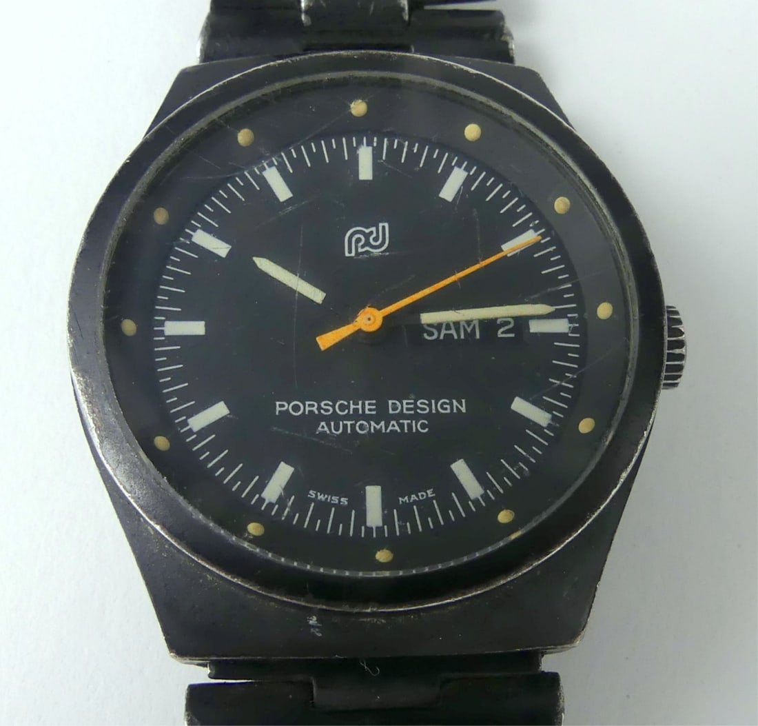 PORSCHE DESIGN AUTOMATIC LADIES WRISTWATCH: Porsche Design automatic day/date ladies wrist watch. Black stainless steel case with pvd coated finish. Double locking strap. #750. Case measures 1 1/4" x 1 1/4" including crown.