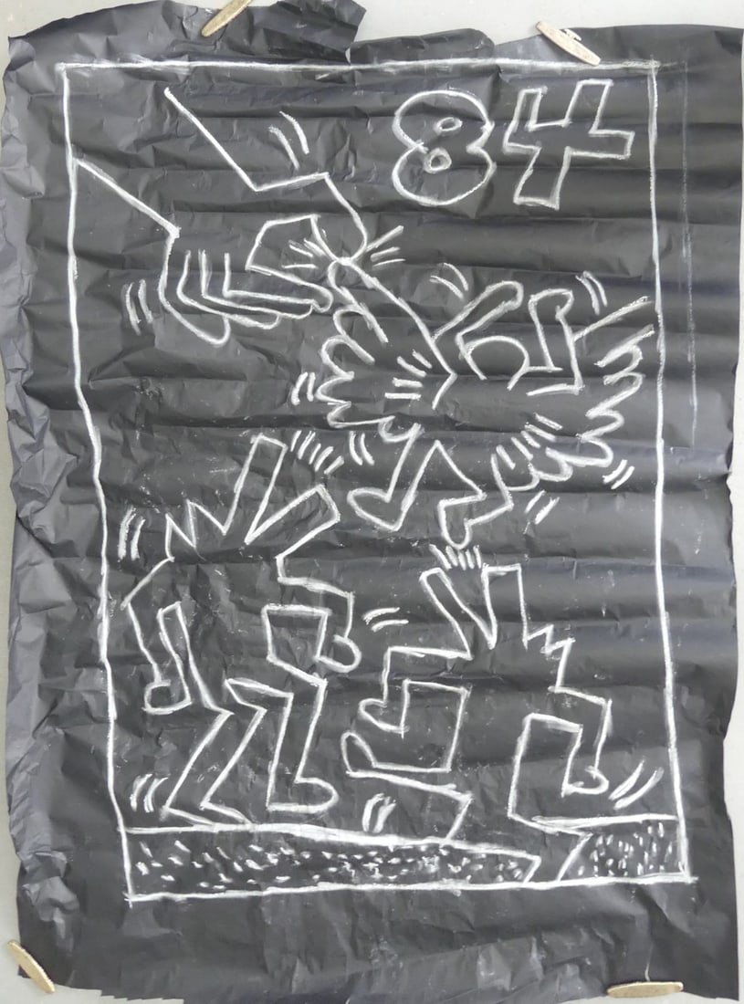 KEITH HARING SUBWAY SERIES CHALK DRAWING ON PAPER: Subway Series chalk drawing on black paper in the manner of Keith Haring (American, 1958-1990). Depicts a hand pulling an angel's wing with a pair of barking dogs below. Dated 1984 upper right. Measur
