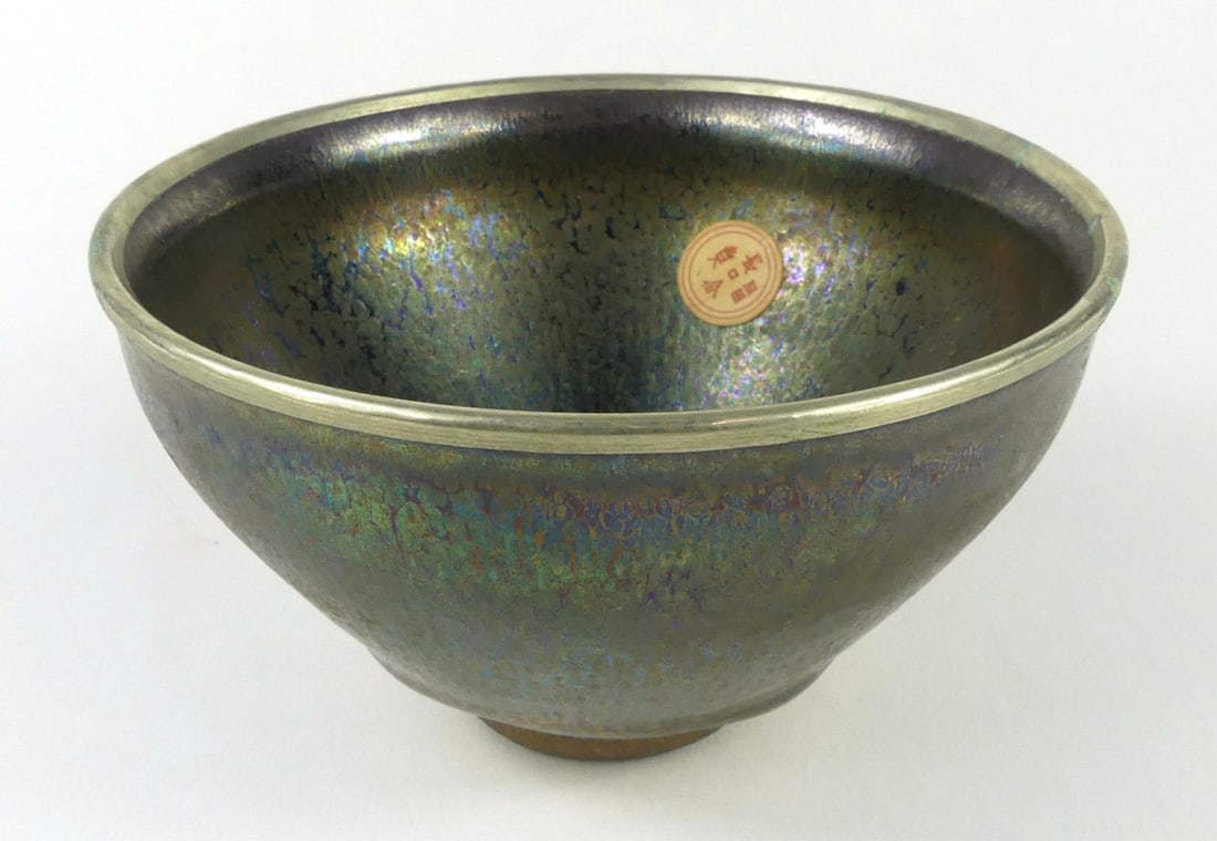 CHINESE JIAN 'OIL SPOT' GLAZE PORCELAIN BOWL: Chinese Jian-type oil spotted porcelain tea bowl with silvered rim. Incised mark to underside. Measures 4 7/8" x 4 7/8" x 2 3/4".