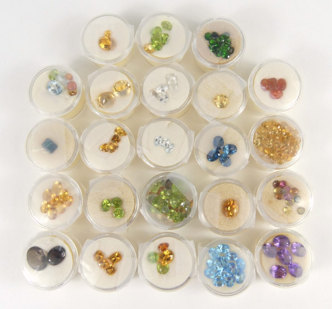 COLLECTION OF SEMI-PRECIOUS STONES: Collection of semi-precious gemstones of various types and sizes. Most are labeled to underside. Includes 23 small cases each measuring 32mm x 32mm x 20mm. Includes amethyst, topaz, quartz, citrine, t