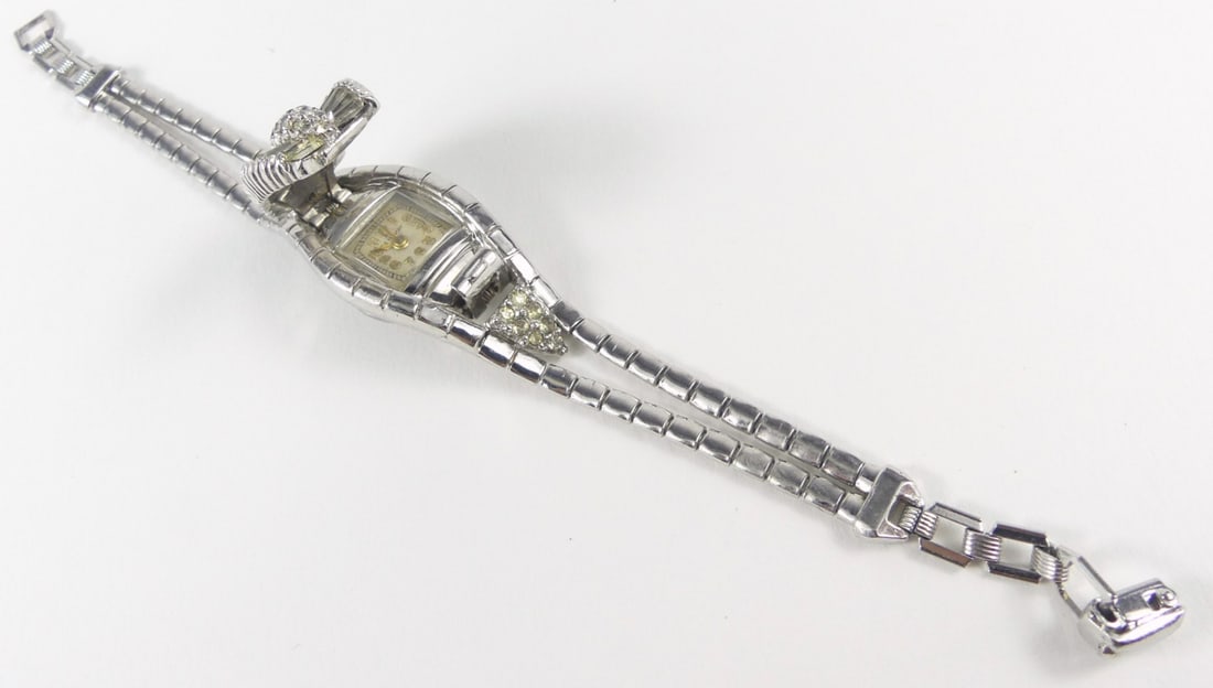 JEWLED WOMAN'S BRACELET w HIDDEN WATCH: Jeweled woman's Bracelet, gold plated with hidden watch. Quartz. Measures 6 1/4" overall length.