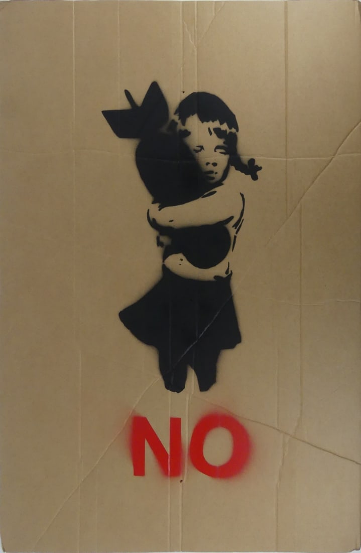 BANKSY 'BOMB HUGGER' STENCIL ON CARDBOARD: Style of Banksy spray paint on cardboard 'Bomb Hugger' Anti-Iraq war placard. Measures 35 3/4" x 23 1/2".