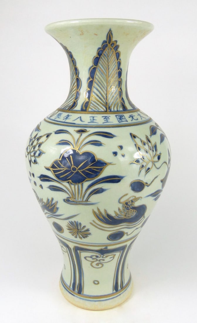 CHINESE BLUE & WHITE GILT PORCELAIN VASE: Chinese blue and white porcelain vase with gilt accents. Decorated with lotus blossoms, birds and geometric motifs. Measures 14 1/2" x 7 1/4" x 7 1/4".