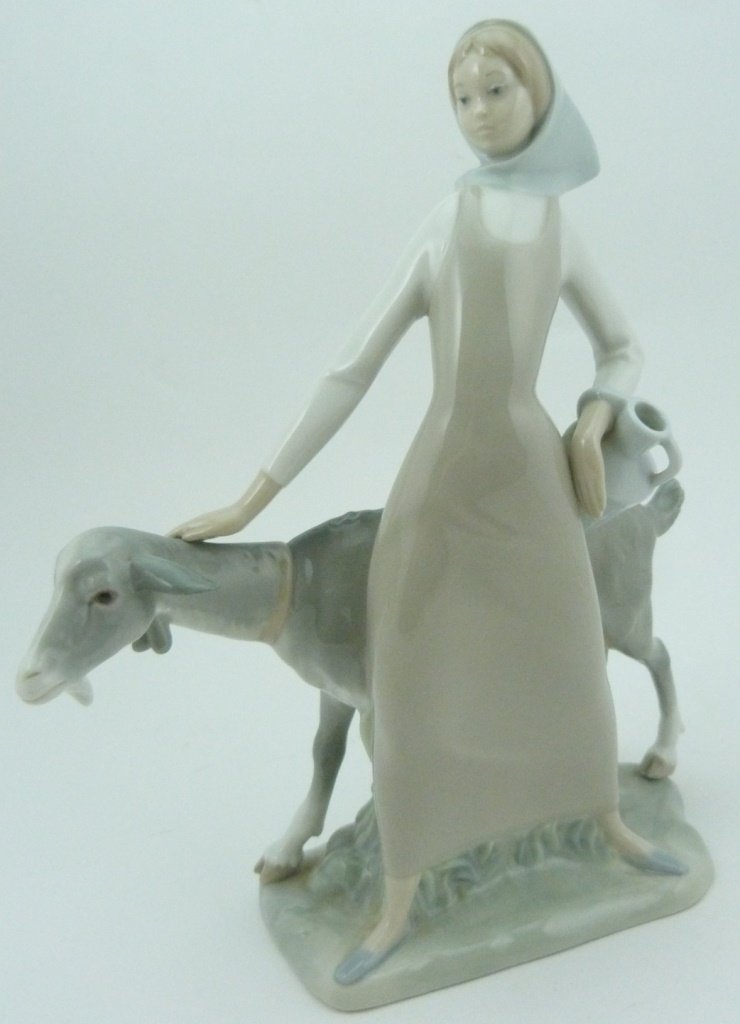 LLADRO RETIRED #4590 GIRL WITH PITCHER & GOAT: Lladro #4590 "Girl with Pitcher and Goat" retired porcelain figure. Measures 11" (27.94cm) height by 9" (22.86cm) width, total weight 1256.8g.