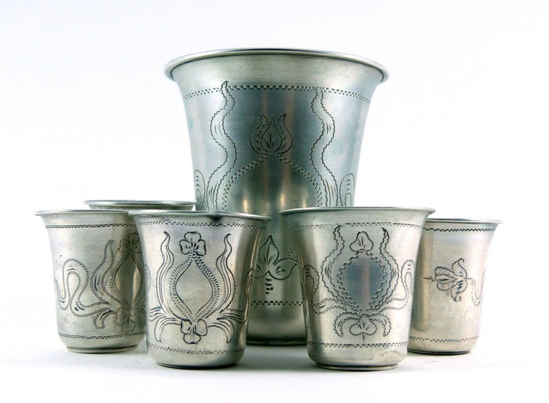 SEVEN PIECE HUNGARIAN SILVER KIDDISH CUP GROUP: Seven piece Austro-Hungarian silversmith silver kiddish cups. Marked "SS" to bottom. Largest measures 3" (8cm) height and smallest 1 1/2" (3cm) height, total silver weight 3.4ozt.