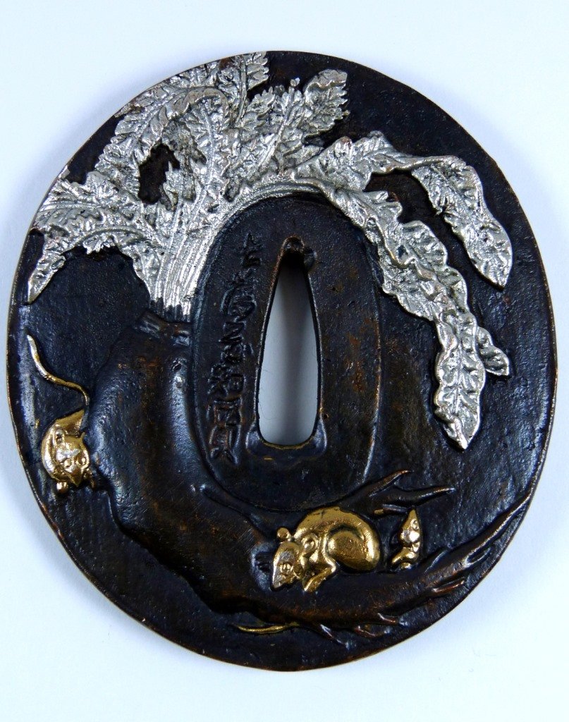 JAPANESE SAMURAI SWORD TSUBA MIXED METAL GUARD: Japanese Samurai Sword Tsuba mixed metal guard. Made from bronze and copper. Depicts calligraphy & mice / rats within leaves decorated in silver & gold gilt. Measures 3 1/4" (8cm) diameter, total weig