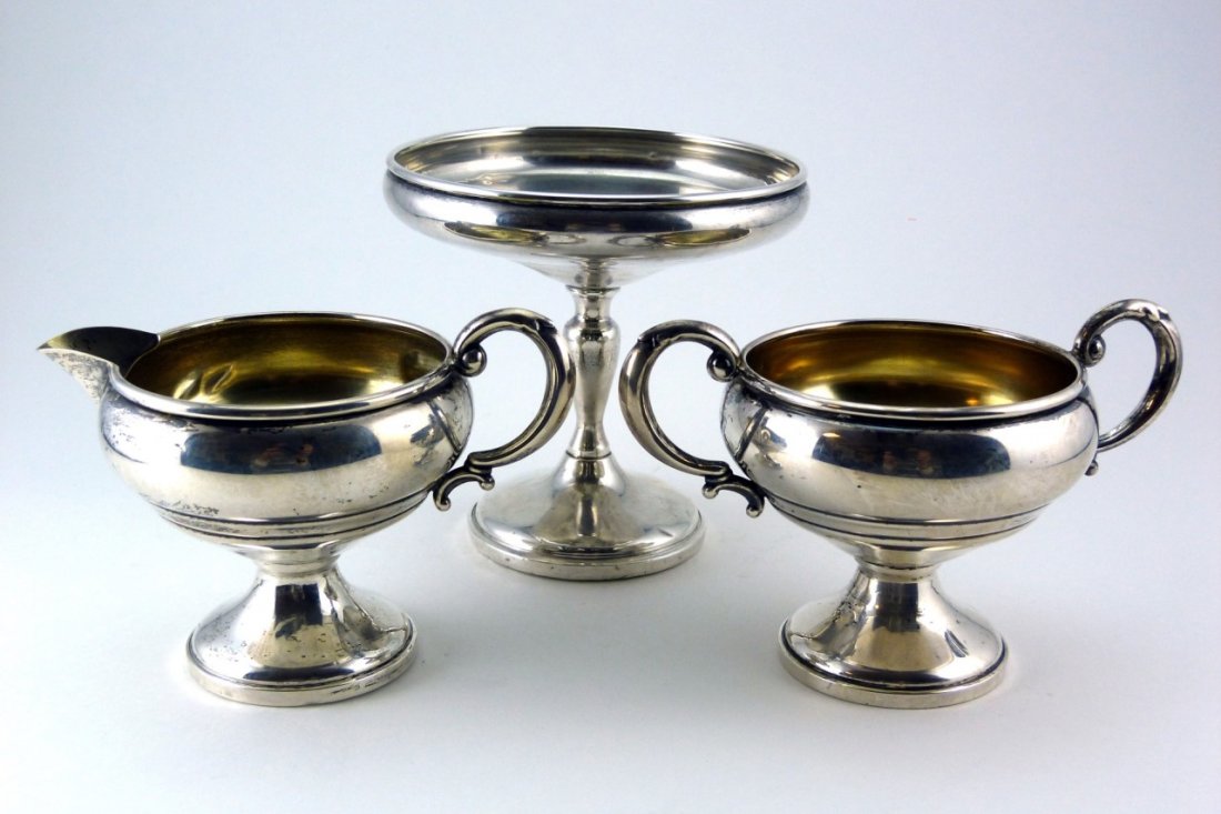 STERLING SILVER WEIGHTED SERVING PIECES: Sterling silver weighted table serving pieces including cream, sugar, and compote. Largest measures 5" (13cm) height, total weight 343g.