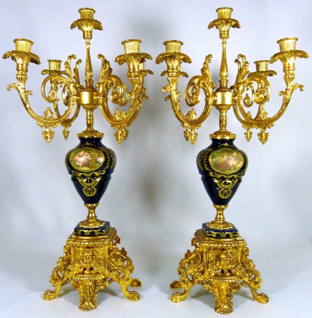 ITALIAN ORMOLU AND PORCELAIN CANDLEABRAS: Italian ormolu and porcelain Limoges style transferware candleabras with decorative gilt accents. Each measures 23" (58cm) height by 13" (33cm) width, total weight approx 7720g.