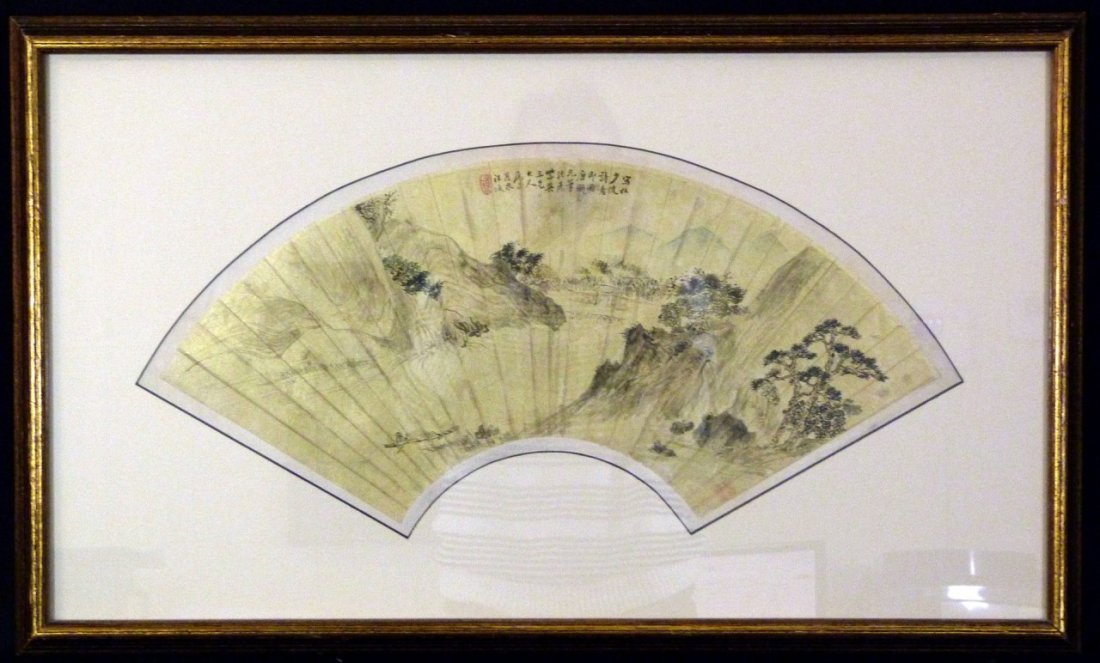 CHINESE LANDSCAPE HAND PAINTED ON PAPER: Chinese landscape hand painting on paper in the form of a fan. Artist seal marks are present upper center. Measures approx 22" (56cm) length by 10" (25cm) height plus approx 3" (8cm) frame and matting