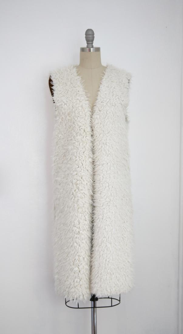 Vintage Ivory Faux Shaggy Fur Reversible Open Vest: This item above is a "Vintage Ivory Faux Shaggy Fur Reversible Open Vest. Excellent condition with minor wear. Vest is reversible to suede. Best fits a medium/large. Please view measurements below for