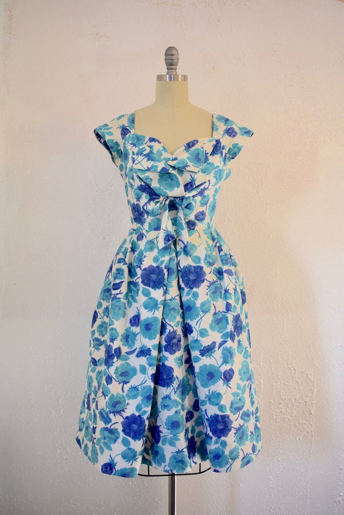 Vintage 1950s Jane Andre Blue Floral Cocktail Dress: This item above is a "Vintage "1950s Jane Andre Blue Floral Cocktail Dress. Excellent condition with minor wear. Light perspiration stains under the arm. Small yellow stain on the bodice of the dress 