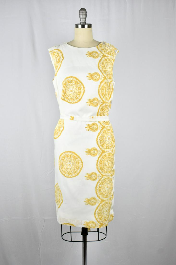 Vintage 1960s Henry Lee Gold/ White Sleeveless Shift: Beautiful Vintage 1960s Henry Lee Gold/ White Sleeveless Shift Dress. Excellent condition with minor wear. Belt attached to wrap around waist. 8 buttons on the left side of the dress for closure. Labe