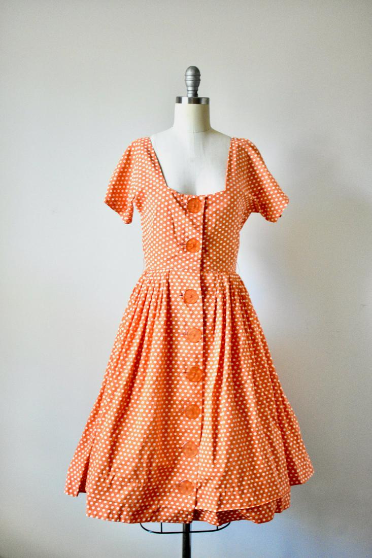Vintage 1950s Orange Polka Dot Novelty Day Dress by Dress Town INC: Vintage 1950s Orange Polka Dot Novelty Day Dress by Dress Town INC. Excellent condition with minor wear.Â¬â€ Beautiful orange buttons to button down for closure. Flared skirt. Fitted waist. Lab