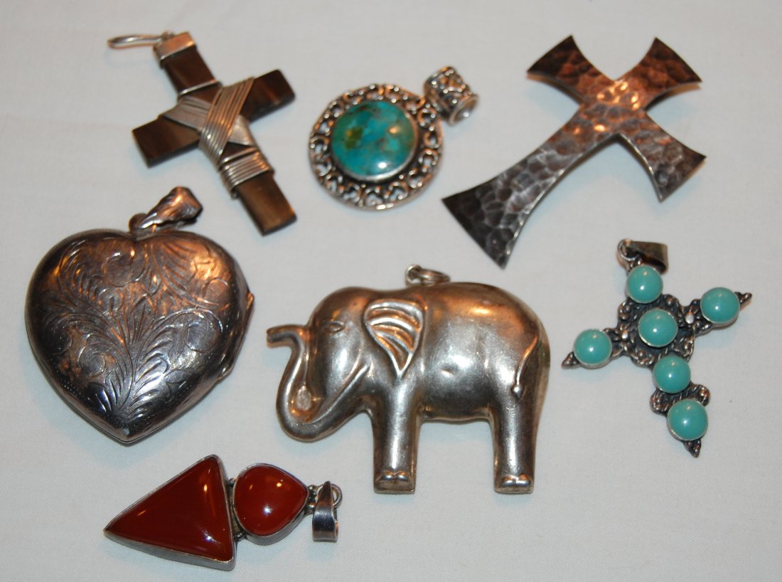 Collection 7 Sterling Pendants: Puffy Heart Locket 57 x 42 mm, hinged marked 925. Round Filigree Pendant with blue stone, marked Thailand and 925, 28 mm diameter. Carnelian pendant 50 x 22 mm marked 925 on bail. Puffy elephant doubl