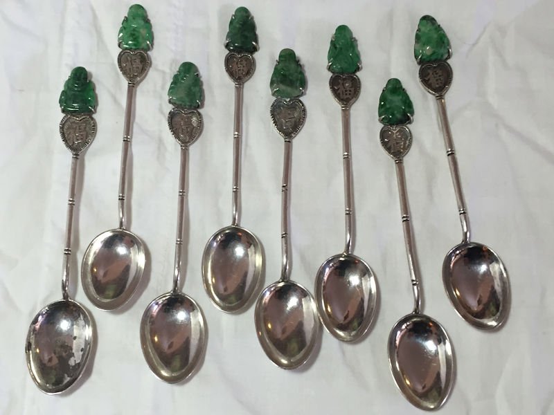 Chinese 20th century Jade and Silver Demitasse Spoons: Set of 8 demitasse spoons each marked Wai Kee Silver, several have hallmarks as well. The neck is in the likeness of bamboo and the carved jade Buddha’s are prong set. Measures 4.25" long 10/80 cm.