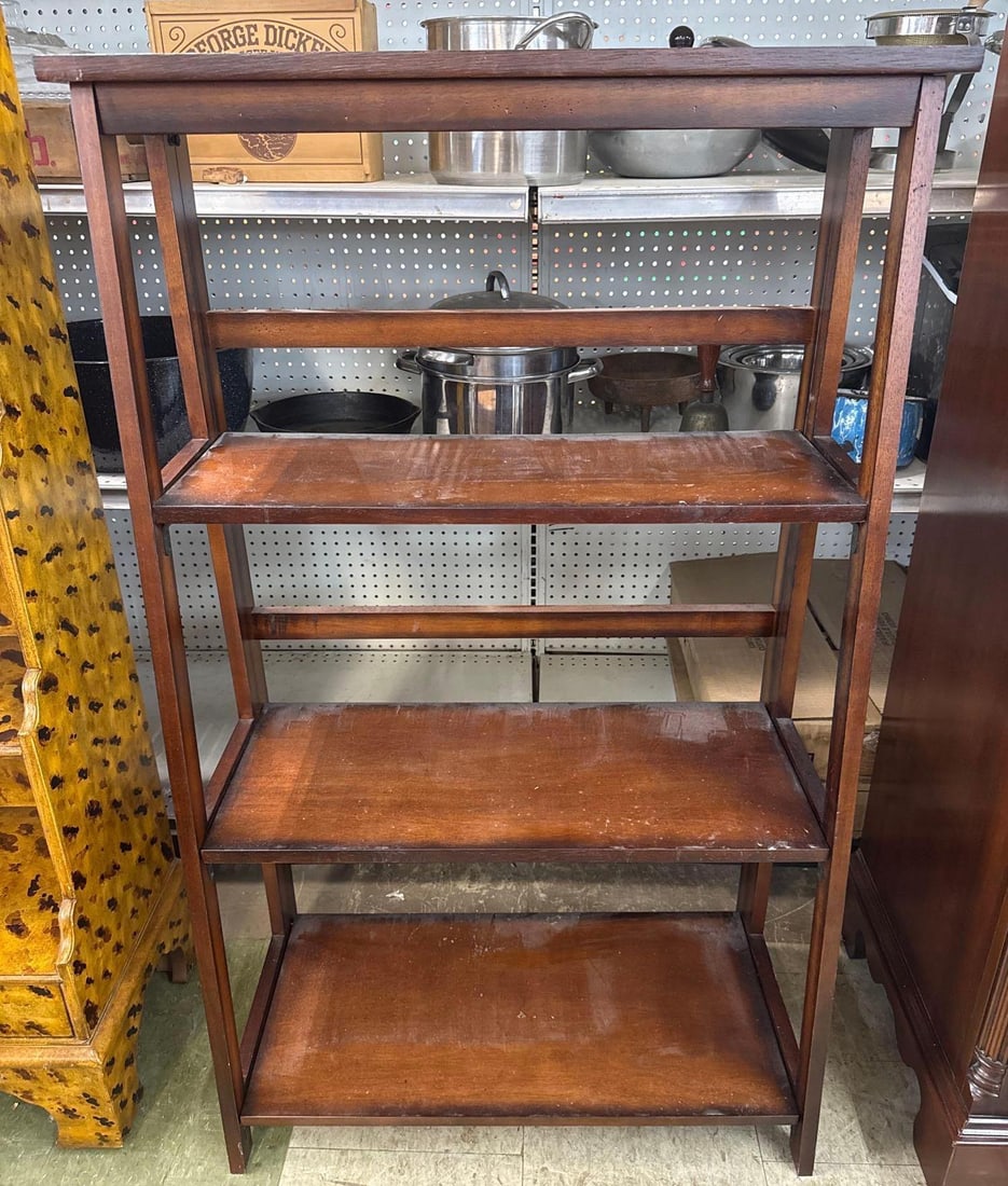 three shelf wooden bookshelf: Angled press board. 25 wide by 13 deep by 41 tall.