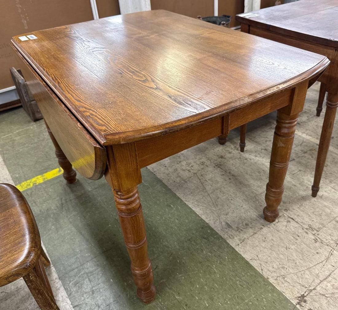 chestnut drop leaf table: oval. 52 inches wide by 43 inches deep by 29 inches tall