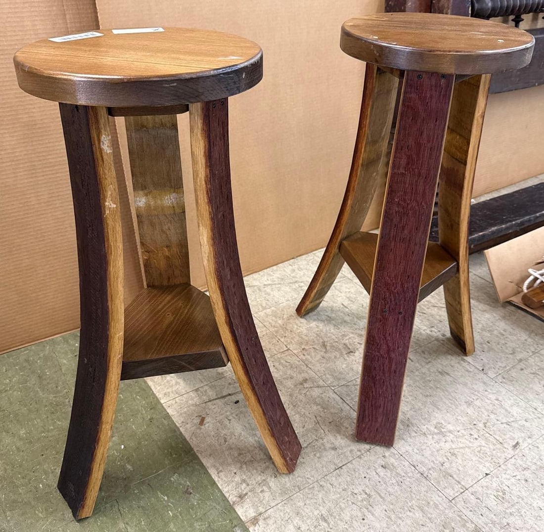 A pair of wooden stools: Legs Made from barrel staves. 26 1/2 inches tall by 18 inches across.