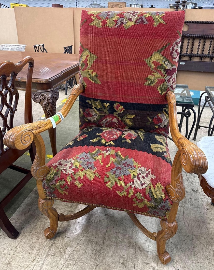 upholstered armchair: Heavily ornamented. 45 inches tall 29 inches wide 33 inches deep.