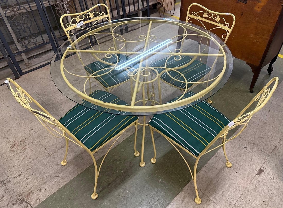 painted yellow wrought iron patio set: Four upholstered chairs and a round glass top table. Chairs are 33 inches tall 17 inches wide 17 inches deep. Table is 29 1/2 inches tall 45 inches wide.