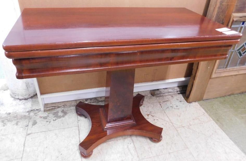 mahogany flip top pedestal table: empire style. closed it measures 28 inches tall 33 1/2 inches wide 16 1/2 inches deep. When its open, it is 33 inches deep.