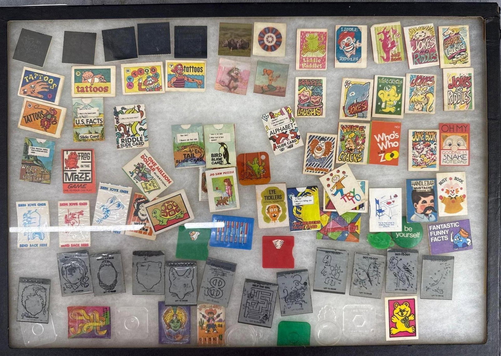 Large lot of vintage cracker jack prizes: In a glass top Display box