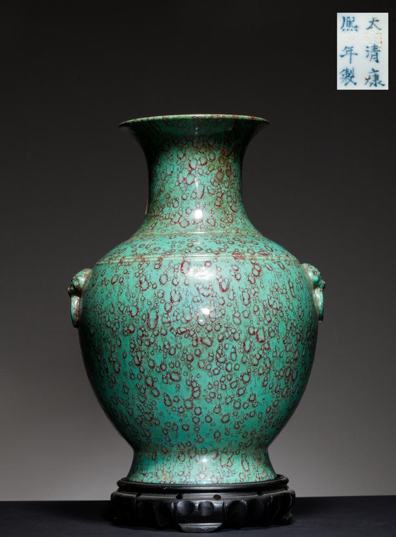 18th Chinese Antique Flambe-Glazed Vase: The pear-shaped body rising to a slender neck and a wide flaring rim, counterbalanced by a splayed footring, the side with two shi-shi head handles suspending the mock ring, covered overall in rich gr