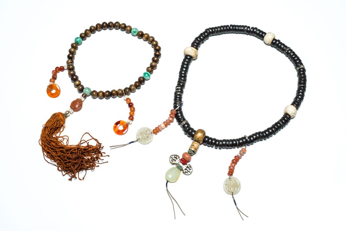 Group of 19th Tibetan Antique Beads: Consisting of two Tibetan beads, one of 36 bone beads equally spaced by four jadeite beads, further enhanced by two strings of agate beads, one of compressed seed beads each of flattened circular form
