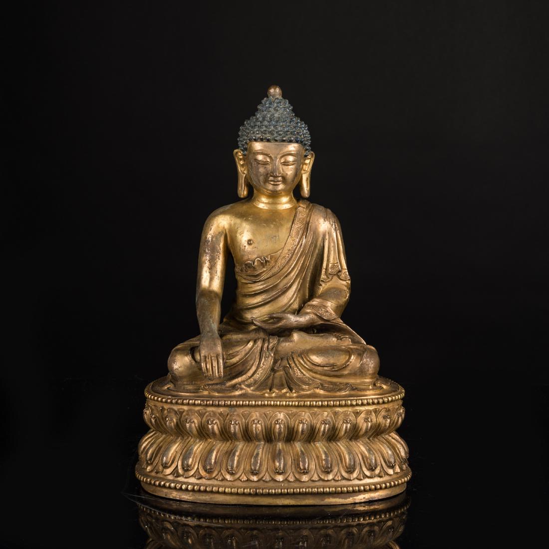 19th Antique Gilt Bronze Medicine Buddha: Seated in dhyanasana on a beaded double-lotus throne, the hands in dhyana mudra and bhumisparsa mudra, and wearing a close-fitting sanghati with beaded hem decorated with incised foliate hem, the plea