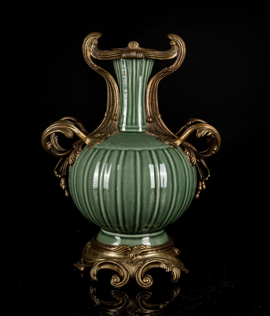 19th Antique Celadon Vase With Gilt-Bronze Mounting: The globular form vase in a celadon glaze with vertical concave-convex grooves, the collar with piasters and handles caste with large curled leaf extending from shoulder to rim, and the base is also e
