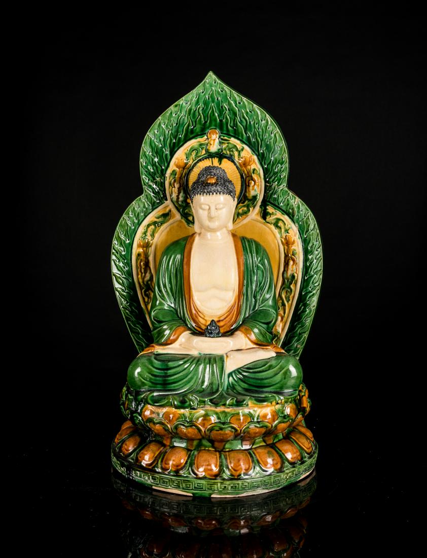 Ming Or Later Antique Sancai Glazed Guanyin: The broad-faced figure with downcast eyes and hands in Dhyana Mudra and having a lotus light on the palm, as he sits on a double lotus plinth, the face with a meditative expression, the hair gathered